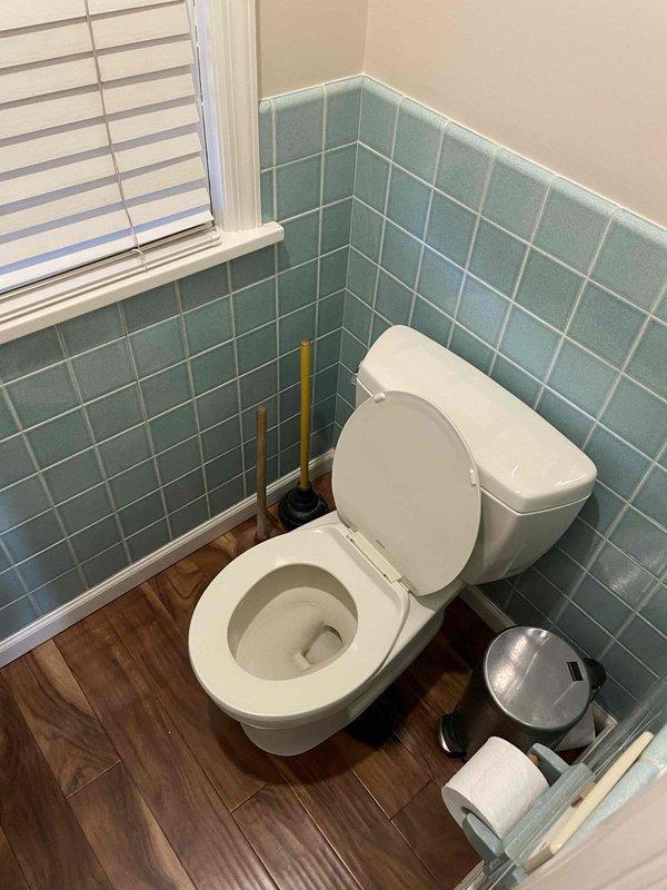Removed and replaced the existing two-piece toilet, including installation of a new wax ring seal, closet bolts, and a new water supply line. Inspected the angle stop and found it heavily corroded with mineral buildup; recommended replacement to ensure reliable shutoff and prevent future leaks. Verified proper seating, secure anchoring, and leak-free operation after reconnecting the supply and flushing.