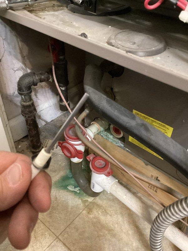 Performed planned heating maintenance on the gas furnace, including inspection and cleaning of the hot surface igniter and ignition components, and replaced the 14x20x1 air filter. Inspected the condensate drain assembly and PVC piping, noting green residue and mineral buildup at the drain connections, and recommended monitoring for leaks. Observed corrosion on the black iron gas piping and dust accumulation on the cabinet, and advised further evaluation of the piping.