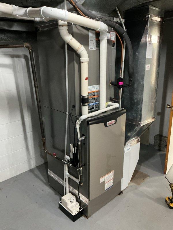 Completed a full HVAC system replacement, installing a Lennox EL297UH090XV48C 90,000 BTU high-efficiency gas furnace with a CK40CT-49C cased evaporator coil and a Lennox ML17KC2-048 4-ton, 230V air conditioning condenser on a level pad with a new electrical disconnect and flexible conduit. The installation included a bump box, galvanized supply plenum and duct transitions, PVC combustion/condensate piping with a condensate pump, insulated refrigerant lines, and an S200 filter cabinet with an Aprilaire 1620 media air cleaner. The system was set up and verified for proper operation.
