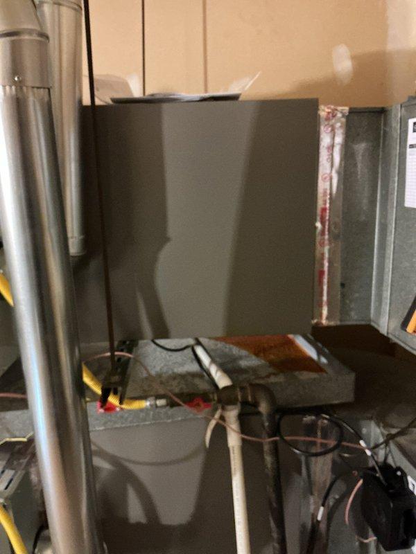 Installed a new Goodman 3.5-ton ML13KC1 condensing unit with a matching CK40HT evaporator coil on the existing furnace, connecting refrigerant lines and condensate drain. Evacuated the system with a vacuum pump, charged with R-410A by weight using a digital refrigerant scale, and verified proper system operation.