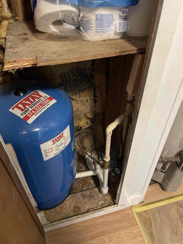 Performed diagnostic evaluation of an approximately 30-year-old gas-fired tank water heater for warranty assessment, with the main water supply found shut off. Inspection identified backflow from the water heater into the well system as the cause of pressure loss at the well tank, and the unit's age and condition were documented for coverage review.