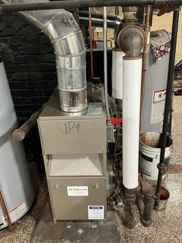 Performed routine maintenance service on boiler system. Inspected electrical connections and junction box wiring, checked copper piping and brass valve fittings, and examined ventilation/exhaust components. System appears functional with normal age-related wear.