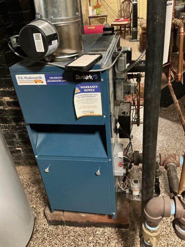 Performed routine maintenance service on two Dunkirk steam boilers located in basement. Inspected interior mechanical components including copper pipes, brass fittings, and electrical connections. All systems functioning properly with no issues identified during the maintenance visit.