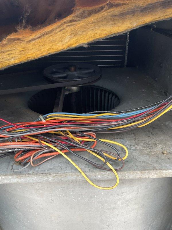 Performed scheduled commercial heating maintenance on rooftop units, documenting significant weathering and rust deterioration on both the tan and white HVAC units. Inspected blower wheel assembly and electrical wiring connections within air handler. Customer provided remaining payment for commercial maintenance agreement plan.