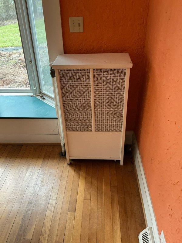 Returned to premises as requested by client to perform radiator disconnection service. Assessed two radiator units: one cast iron radiator showing significant deterioration with peeling paint and rust, and a second unit with decorative mesh grille panels. Successfully completed disconnection procedure of both heating elements from the boiler system as requested.