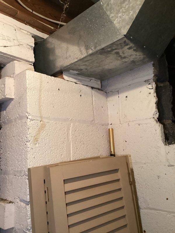 Completed electrical panel installation with proper conduit routing and connection. Multiple circuit breakers were installed with appropriate red, white, and black wiring, and all conduit pipes were properly secured to the wooden backing board with appropriate connectors and fittings.