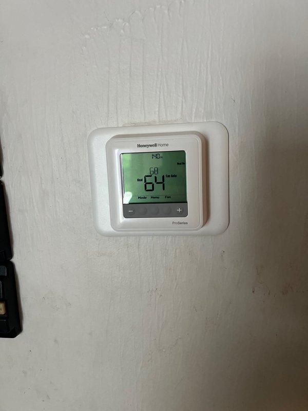 Successfully replaced garage heater unit with new system. Installed Honeywell Home digital thermostat with cooling functionality. Connected copper pipe assembly with shut-off valve to complete the installation.