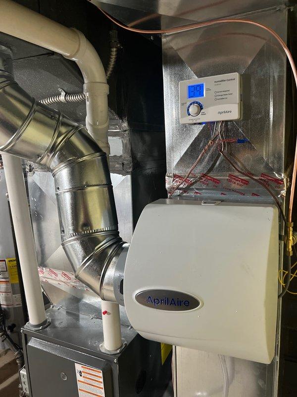 Successfully installed AprilAire 600 bypass humidifier and air scrubber as scheduled. Mounted humidifier unit with digital humidity control panel featuring LED display and adjustment capabilities. All components properly connected to existing ductwork with secure fittings and appropriate drainage lines in place.