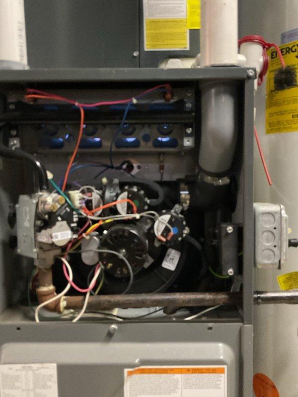 Performed routine furnace maintenance service including inspection of burner assembly and flame pattern. Checked control board functionality and all electrical connections. System is operating correctly with proper combustion indicated by blue flames at the burners. All components and wiring harness in good working condition.