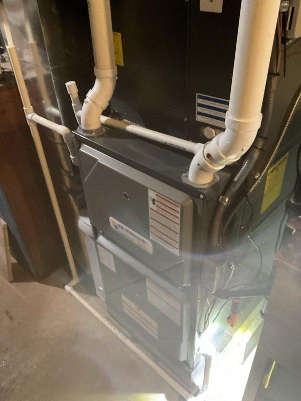 Responded to water leak complaint at residential property. Inspected basement HVAC system and identified excessive water leakage from humidifier component affecting both the office area and furnace room. Serviced the connection point where condensate drainage system was compromised, resolving the leak issue.