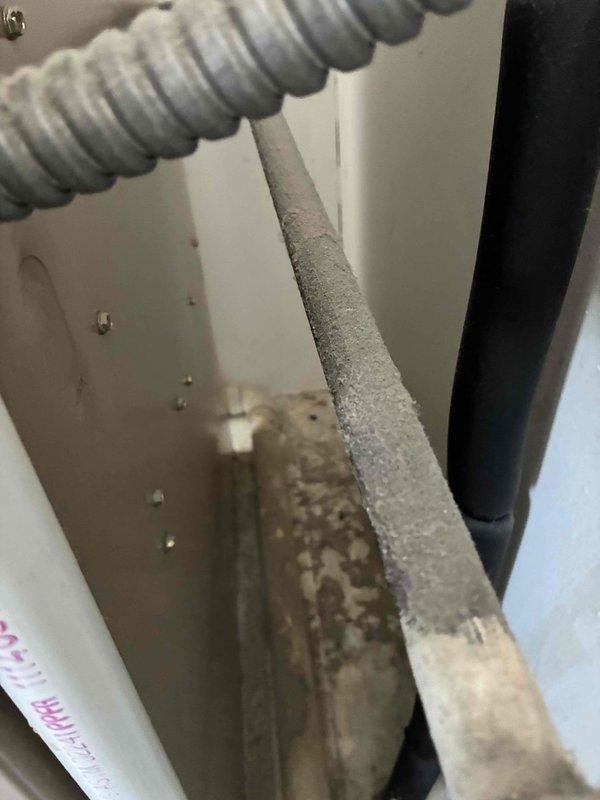 Performed scheduled monthly heating system maintenance. Observed deteriorated and dust-covered insulation with worn edges inside unit. Identified potential ventilation issues as evidenced by the corrugated conduit condition and general dust accumulation throughout the system components.