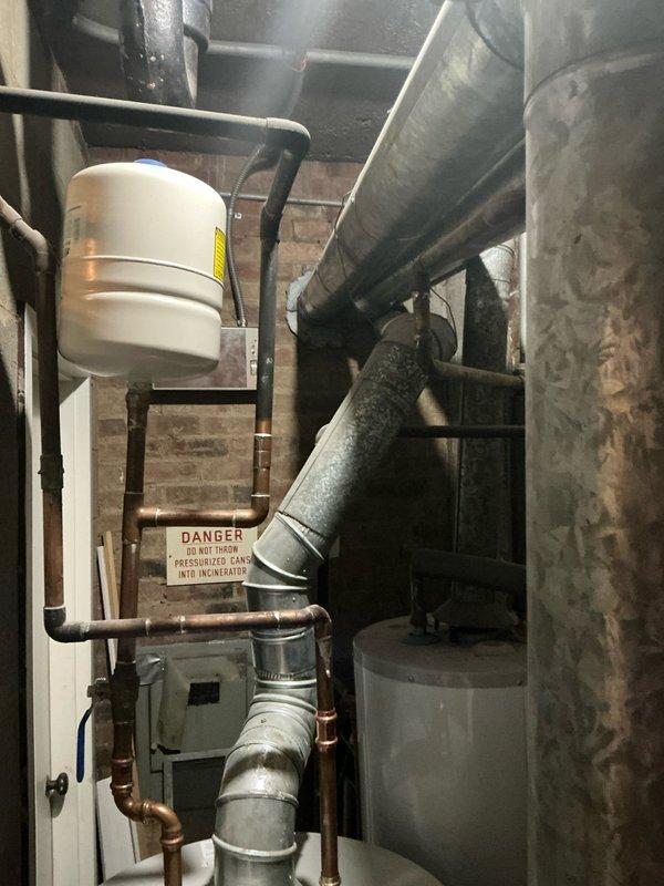 Performed evaluation of aging boiler system in basement mechanical area. Noted significant wear on primary circulation pump, extensive corrosion on copper piping connections, and recommended replacement options given age of existing equipment. System requires modernization to improve efficiency and reliability.