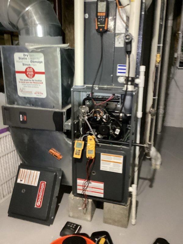 Performed routine furnace maintenance service including inspection of all internal components with front panel removed. Conducted electrical testing using UEI G2 Phoenix multimeter, checking resistance readings (55.0 ohms) and verifying proper electrical connections throughout system components to ensure optimal operation.