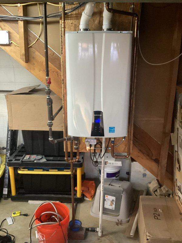 Performed maintenance on Navien tankless water heater experiencing inconsistent heating issues. Conducted descaling procedure on heat exchanger to remove mineral buildup affecting performance. Verified proper venting connections and inspected all plumbing components, restoring unit to optimal operating temperature and efficiency.