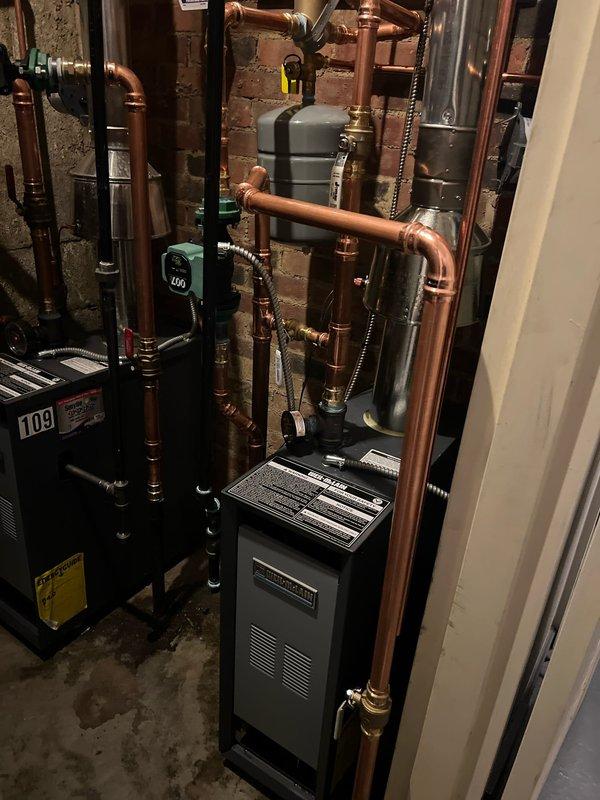 Successfully completed boiler installation with comprehensive copper pipe network and proper connections throughout the system. Installed all required brass fittings, valves, and pressure gauges to ensure optimal operation and system monitoring capabilities. All components were properly mounted and tested to confirm proper functionality before completion.