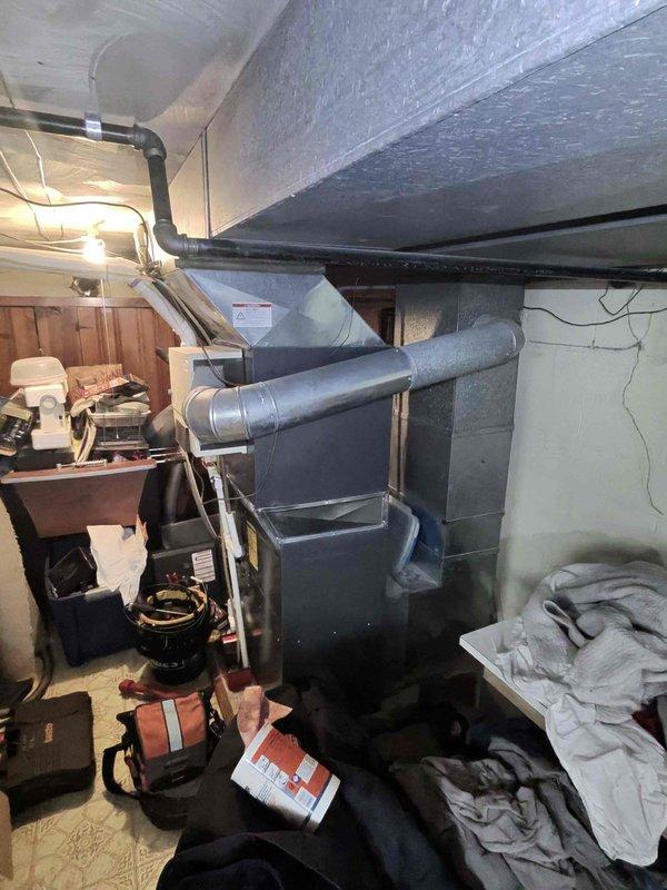 Performed routine heating maintenance on system located in basement utility room. Cleaned and inspected blower wheel assembly, confirming proper operation of squirrel cage fan and motor shaft connection. System functioning normally with all ductwork and connections in good condition.