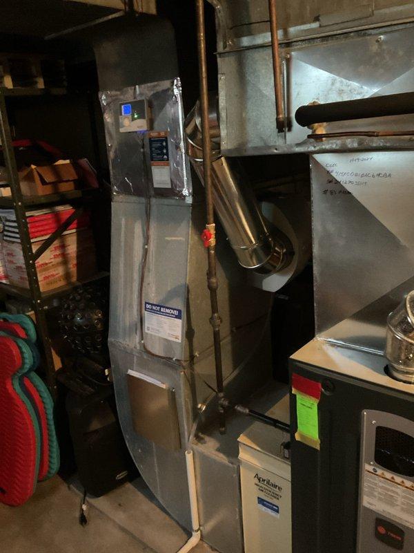 Performed first-year heating maintenance on residential furnace system. Inspected furnace unit with digital control panel, associated ductwork, and copper line connections in basement mechanical room. System appears to be in functional condition with no issues requiring immediate attention.