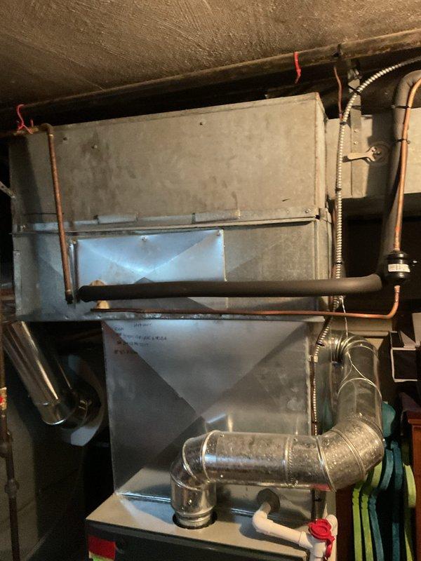 Performed first-year heating maintenance on residential furnace system. Inspected furnace unit with digital control panel, associated ductwork, and copper line connections in basement mechanical room. System appears to be in functional condition with no issues requiring immediate attention.