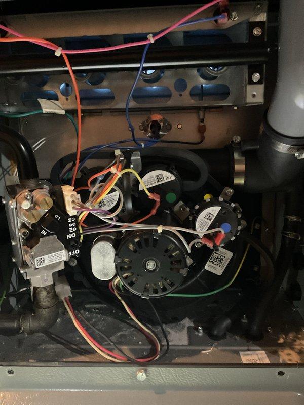 Responded to customer complaint of heating system producing only lukewarm air. Upon inspection of P.K. Wadsworth furnace, found issues with blower motor assembly affecting proper heat distribution. Serviced internal electrical components and gas valve assembly to restore normal operation. System now producing adequate heat with proper airflow.