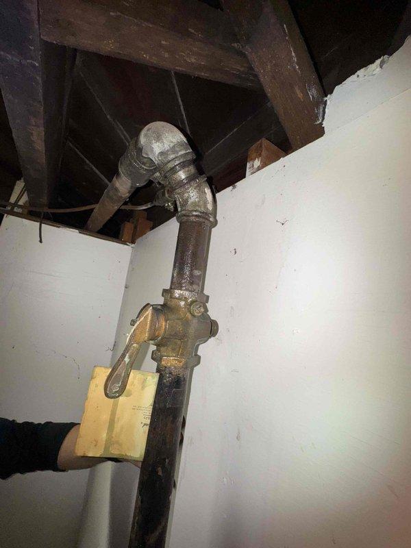 Performed routine maintenance on 20-year-old steam boiler system as part of scheduled biannual service agreement. Inspected aging pipe infrastructure showing signs of corrosion and identified moisture damage with possible mold growth on wall near electrical connections. Recommended addressing deteriorating wall conditions and proper securing of electrical components to prevent safety hazards.