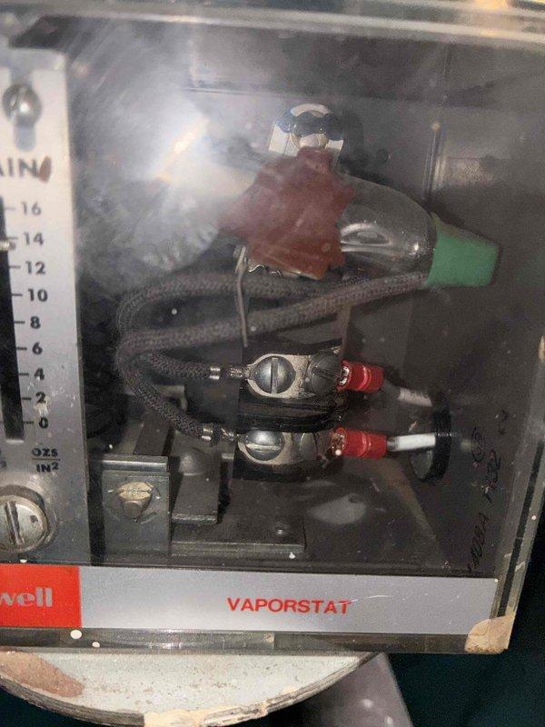 Performed scheduled heating maintenance on system. Inspected Honeywell Vaporstat pressure control device which appeared functional with no visible damage. Examined burner tubes and heat exchanger components which showed proper ignition and flame pattern during operation.