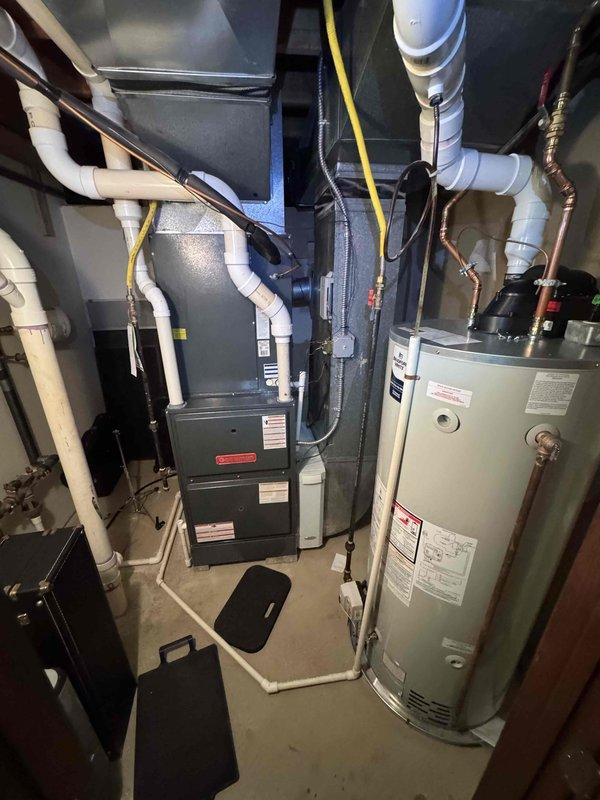 Performed routine maintenance on residential furnace system. Inspected sheet metal ductwork connections and verified proper installation of all components. Examined mechanical room setup including furnace unit, associated PVC venting, and proper clearances from water heater.