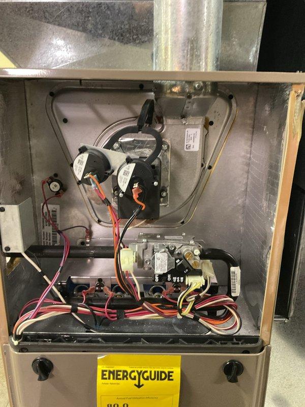 Performed monthly heating maintenance on residential HVAC system. Inspected furnace with access panel removed, checked all electrical components including pressure switches, circuit boards, and wiring connections. Examined gas valve assembly and verified proper operation of the complete heating system.