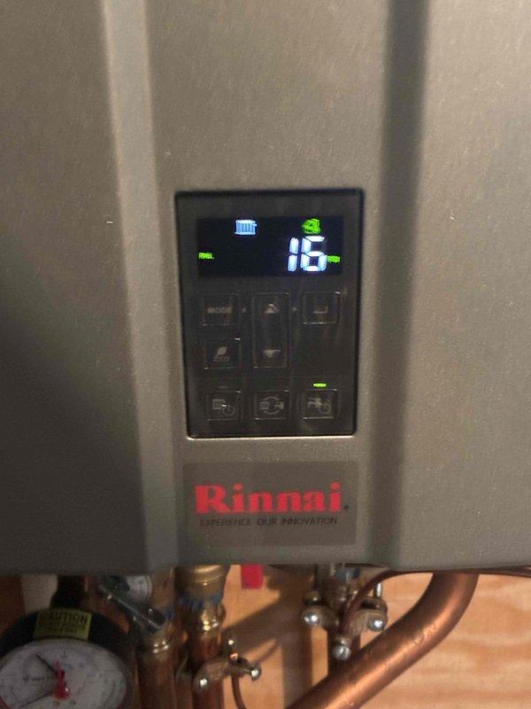 Responded to customer complaint of low pressure error message on Rinnai boiler system. Diagnostic inspection revealed system pressure had dropped to 16 PSI as displayed on the control panel. Recharged the system through the manifold fill valve to restore proper operating pressure and verified normal operation with no error messages.