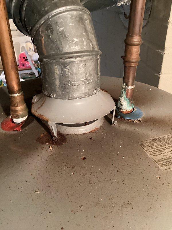 Conducted inspection of water heater system in utility area. Observed significant corrosion on copper pipe connections and mineral buildup at joint points. Provided customer with requested quote for water heater replacement based on assessment of aging unit and deteriorating connections.