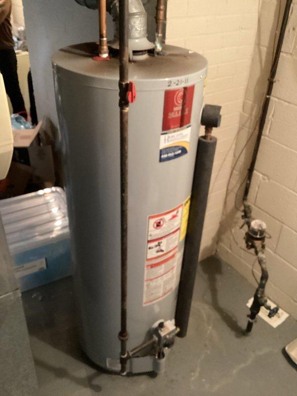 Conducted inspection of water heater system in utility area. Observed significant corrosion on copper pipe connections and mineral buildup at joint points. Provided customer with requested quote for water heater replacement based on assessment of aging unit and deteriorating connections.