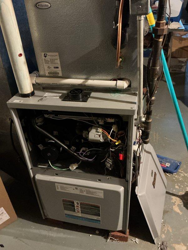 Performed routine maintenance on aging Goodman heating system. Accessed internal components to inspect electrical connections and tested blower motor operation. System is functioning adequately despite age, with all components cleaned and verified operational.
