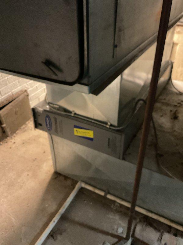 Performed comprehensive winter heating tune-up on aging furnace system located in basement utility area. Inspected unit showing normal wear with some discoloration on upper cabinet section. Verified proper operation of Emerson programmable thermostat (currently set at 67°F in Heat mode) and confirmed system cycling appropriately.