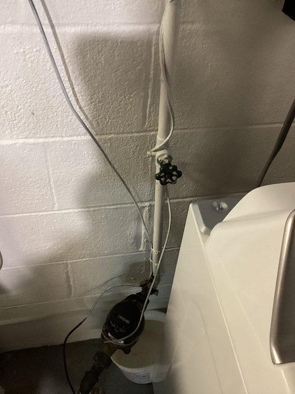 Responded to service call for leaking shut-off valve behind washer/dryer unit. Inspected plumbing system including Kohler pump installation and kitchen sink fixtures. Replaced faulty valve to resolve active water leak that customer had been containing with a bucket.