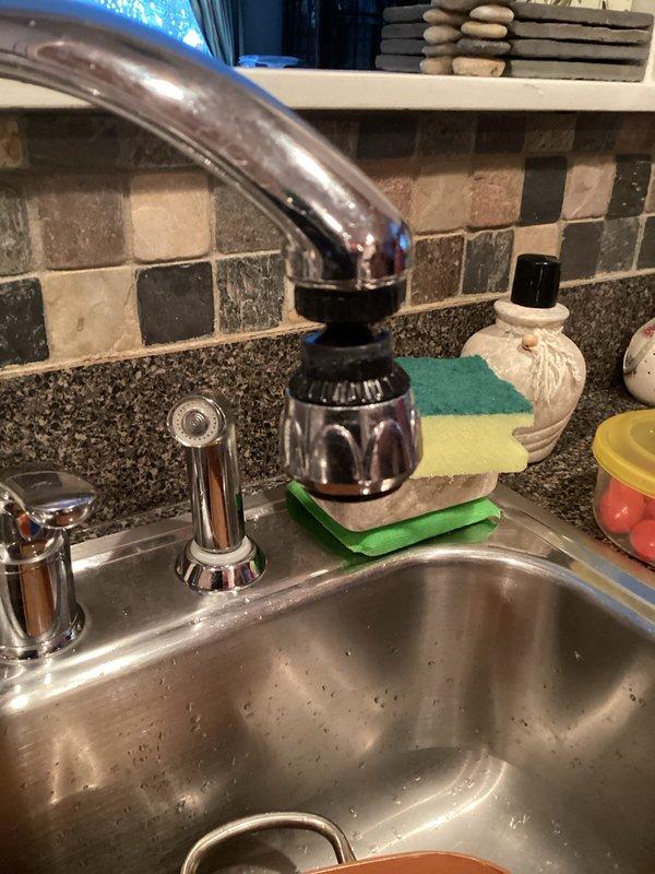 Responded to service call for leaking shut-off valve behind washer/dryer unit. Inspected plumbing system including Kohler pump installation and kitchen sink fixtures. Replaced faulty valve to resolve active water leak that customer had been containing with a bucket.