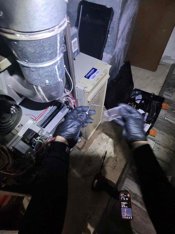 Performed monthly heating maintenance service on HVAC system. Inspected control module connections and wiring while wearing protective gear. System exhibited signs of mineral buildup and discoloration on components that were documented with photographs for future reference.