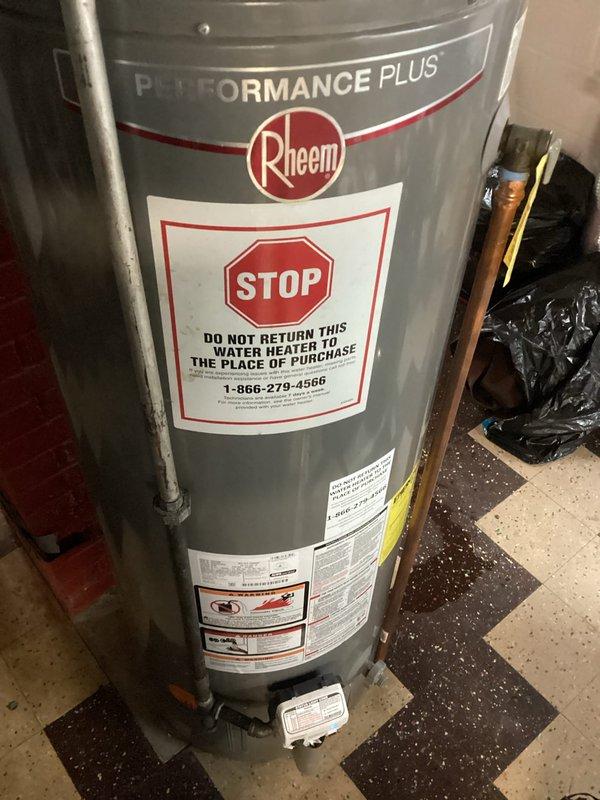 Responded to customer complaint of water leakage around the base of their Rheem Performance Plus water heater. Conducted full inspection of the unit, noting significant corrosion on one of the connecting pipes. Replaced the deteriorated pipe, sealed the tank base properly, and verified proper venting through the wall penetration. System now operating correctly with no leaks detected.
