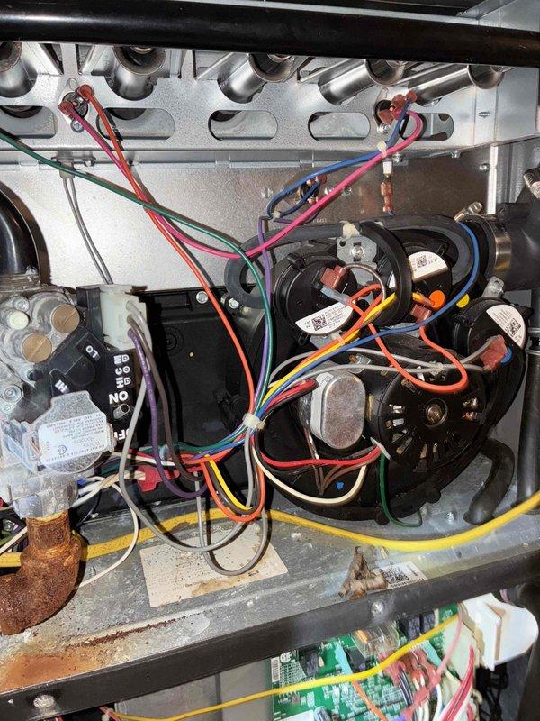 Performed routine heating maintenance on aging system (10+ years old). Inspected blower motor assembly and internal wiring connections. Noted minor corrosion on copper pipe connection that should be monitored but is currently functioning adequately.