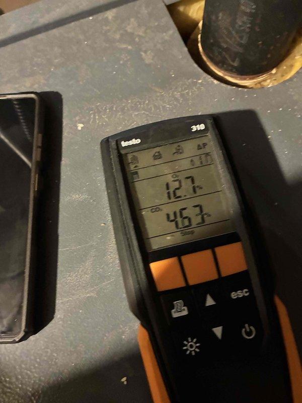 Performed routine boiler maintenance including combustion analysis with gas analyzer showing readings of 127/46.3. Inspection revealed significant corrosion and oxidation on brass pipe fittings, particularly at valve assembly with blue handle. Noted moisture accumulation in enclosure that requires monitoring.
