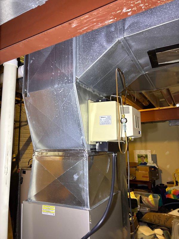 Performed diagnostic inspection of upstairs furnace system reporting no heat output. Assessment revealed significant existing damage with repair costs exceeding replacement value. Presented customer with replacement options for the aging unit. Current installation includes metal ductwork with junction box connections in utility area.