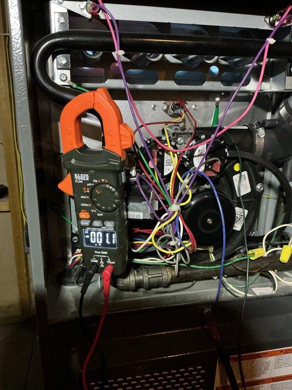 Responded to no heat complaint where furnace was cycling on and off. Diagnostic testing with Klein Tools clamp meter revealed electrical issues with the system. Identified condensate drainage problem evidenced by active water dripping from PVC drain pipe. Serviced heat pump unit which showed signs of winter operation stress. Resolved cycling issue and restored proper heating function.