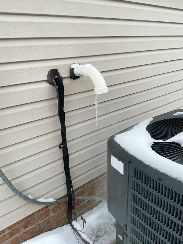 Responded to no heat complaint where furnace was cycling on and off. Diagnostic testing with Klein Tools clamp meter revealed electrical issues with the system. Identified condensate drainage problem evidenced by active water dripping from PVC drain pipe. Serviced heat pump unit which showed signs of winter operation stress. Resolved cycling issue and restored proper heating function.