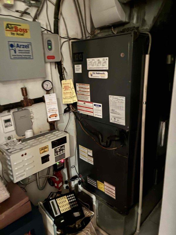 Performed scheduled maintenance service on client's boiler system. Inspected electrical control panel containing temperature sensors/thermostats and verified proper wiring connections. Examined AirBoss furnace unit, checked digital control displays, and confirmed all components were functioning within normal operating parameters.