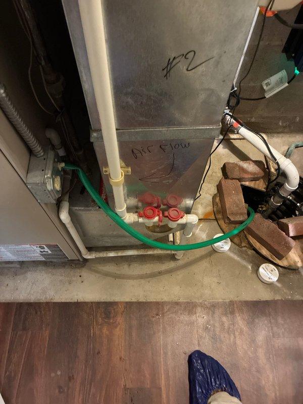 Performed diagnostic assessment on west side HVAC system which was exhibiting leakage issues and requiring high-cost repairs. Inspected furnace/air handler unit (labeled "#2") with connected refrigerant lines and valve assembly. Examined thermostat wiring configuration, noting proper terminal connections for C, O, B, W and RH, RC, G, Y circuits, which appeared intact with no visible damage.