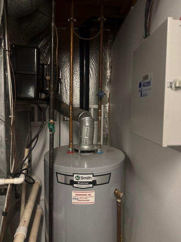 Performed diagnostic inspection on A.O. Smith ProLine water heater as requested during follow-up visit. Confirmed presence of old seat valve for water heater shut-off and verified absence of bonding and expansion devices on system as noted in previous service report. Additionally, assessed garage drain issue reported by customer.