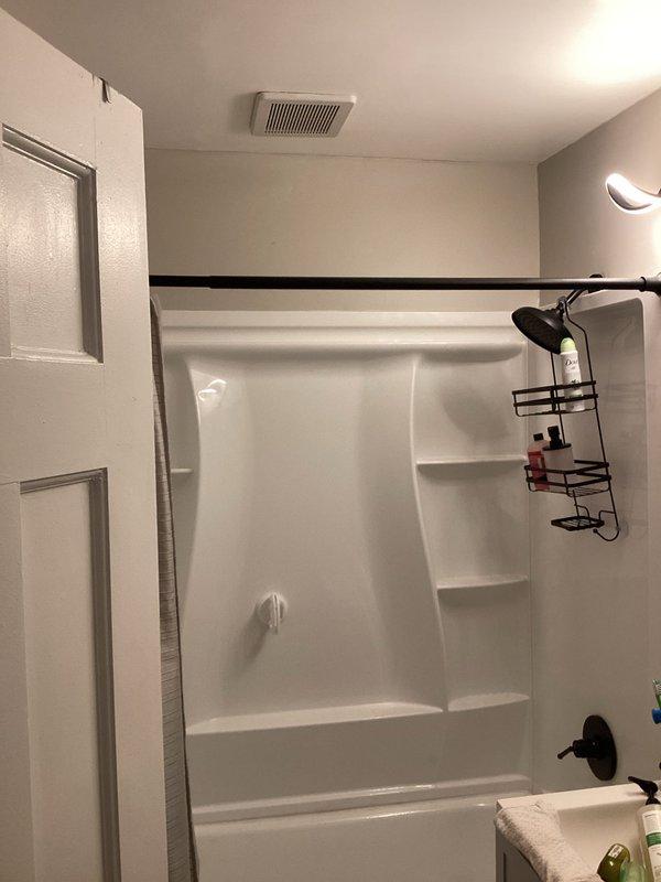Diagnosed and repaired water leak from bathroom exhaust fan vent. Inspection revealed moisture intrusion through the ceiling-mounted ventilation unit above the shower/tub enclosure. Successfully stopped water leakage and restored proper functionality of the exhaust system.