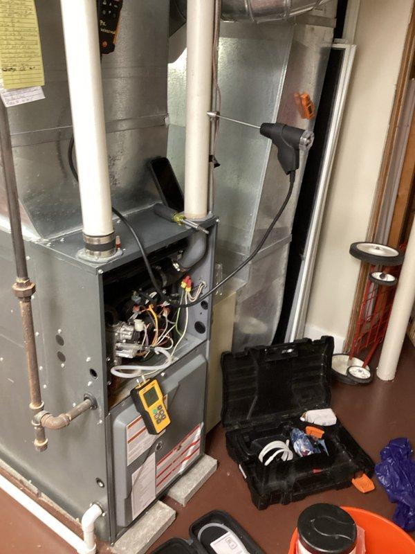 Performed routine monthly heating maintenance on residential furnace system. Conducted diagnostic testing with digital measurement equipment to verify proper operation. Inspected internal components, wiring, and connections with front panel removed; all systems functioning normally.