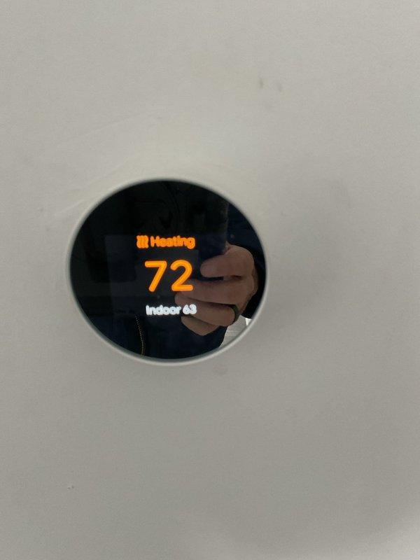 Responded to emergency no-heat call to find outdoor unit completely buried in snow, preventing proper operation. Cleared snow accumulation from unit and verified proper airflow. System resumed normal function with thermostat now accurately controlling heating cycle as confirmed by temperature reading of 72°F.