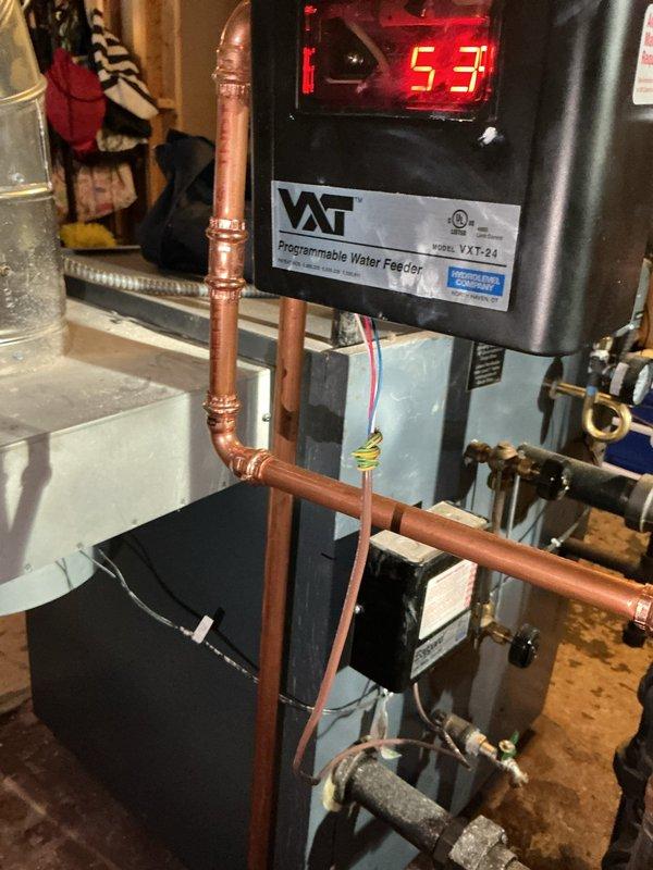 Responded to emergency no-heat call for radiant boiler system installed less than 5 years ago. Diagnostic inspection revealed low water level in system as indicated by VAT Programmable Water Feeder control unit. Adjusted system pressure from 17 PSI to appropriate operating range and reset controller, restoring normal heat function.