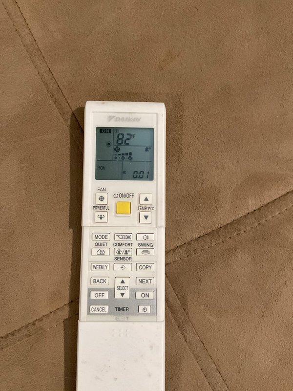 Responded to customer complaint of no heat in one room with a Daikin mini-split system. Inspection revealed severely clogged air filters causing restricted airflow. Removed, cleaned, and reinstalled filters, restoring proper system operation. Unit now maintaining proper temperature (82°F) per remote control verification.