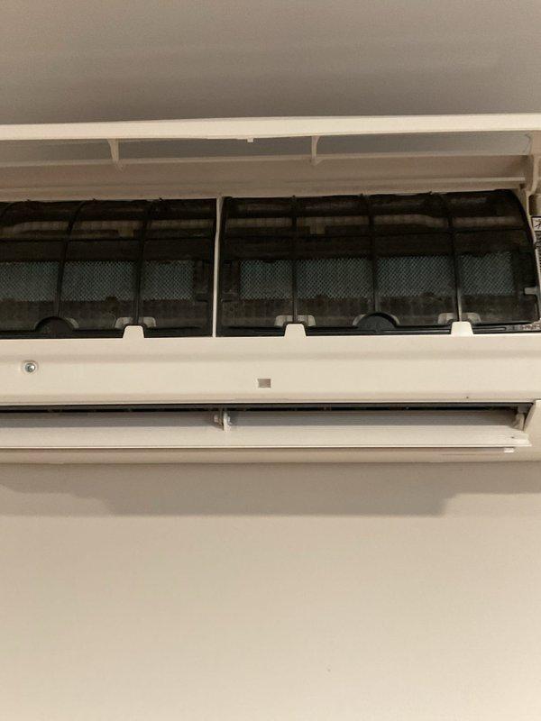 Responded to customer complaint of no heat in one room with a Daikin mini-split system. Inspection revealed severely clogged air filters causing restricted airflow. Removed, cleaned, and reinstalled filters, restoring proper system operation. Unit now maintaining proper temperature (82°F) per remote control verification.